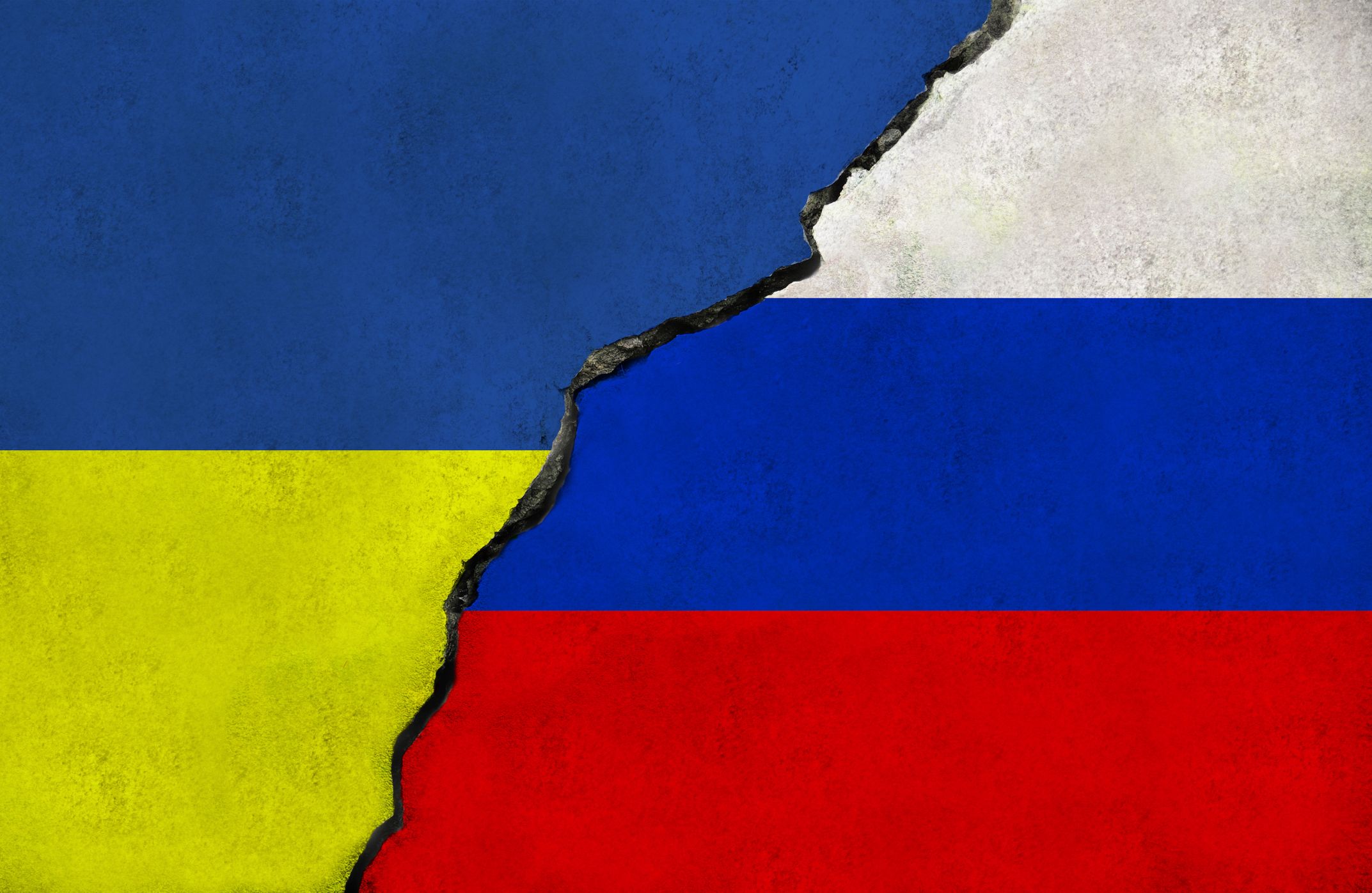 Torn Ukrainian and Russian flags intersect