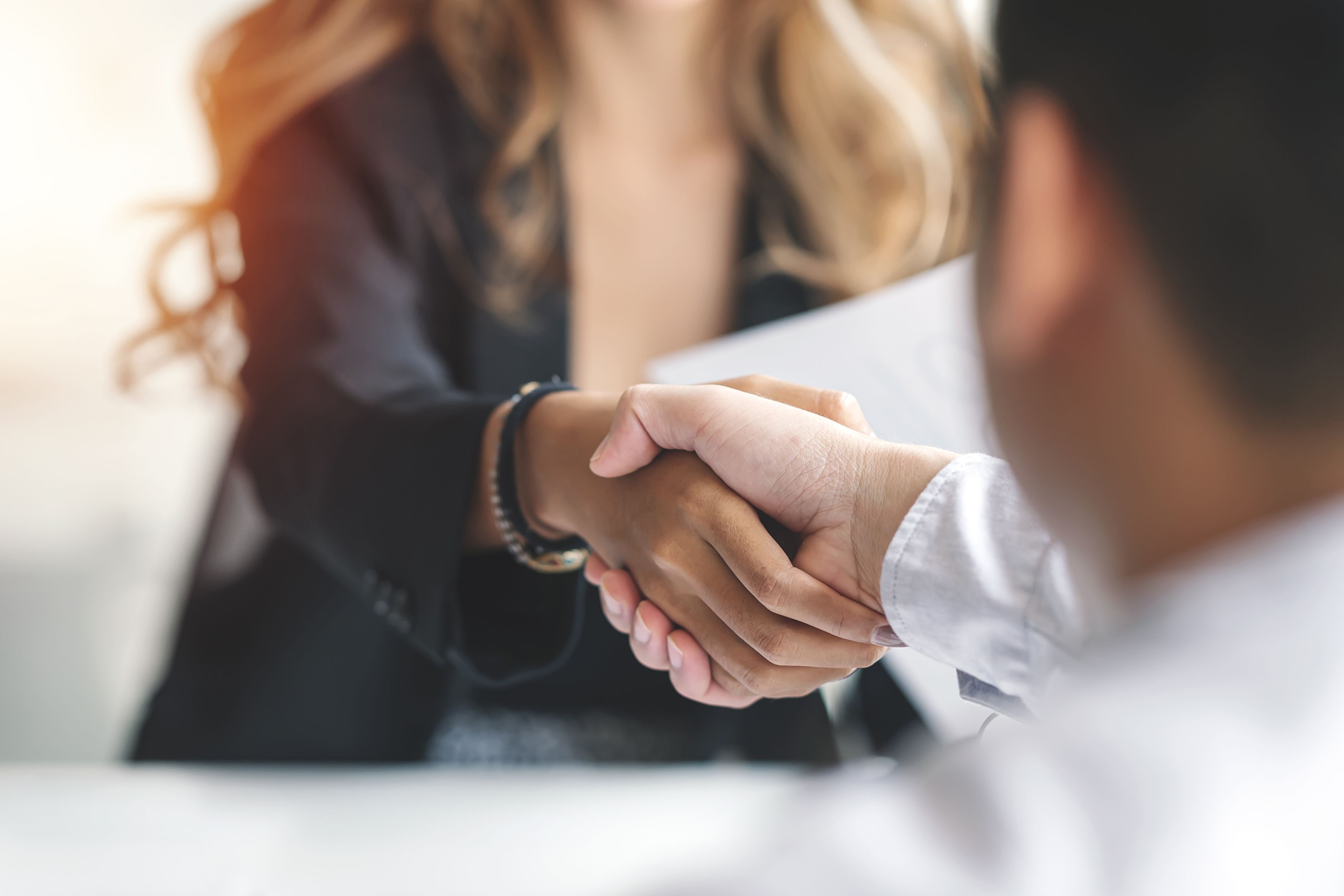 people sitting down near table with assorted laptop computers